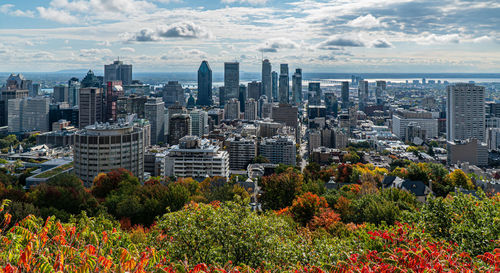 Aerial view of buildings in city against sky