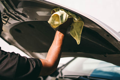 Midsection of man holding plant