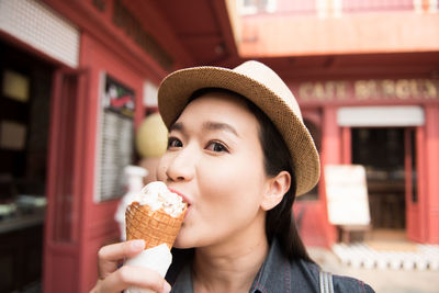 Portrait of mid adult woman eating ice cream