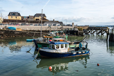 Boats moored on sea against sky