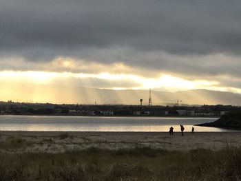 Scenic view of beach against sky during sunset