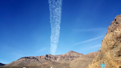 Low angle view of rock formation against clear blue sky