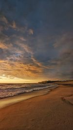 Scenic view of beach against sky during sunset