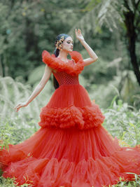 Rear view of woman standing on field