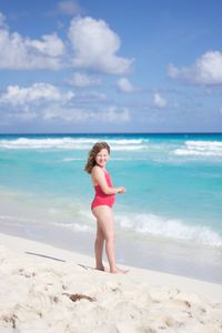 Girl standing at beach during summer