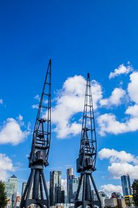 Low angle view of crane against sky