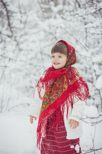 Girl in ancient ukrainian clothes in the winter in the forest