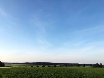 Scenic view of grassy field against cloudy sky