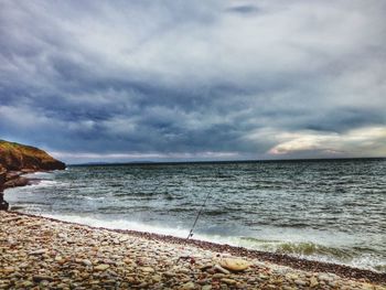 Scenic view of sea against cloudy sky