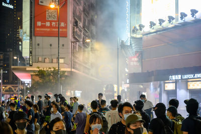 Group of people on street in city at night