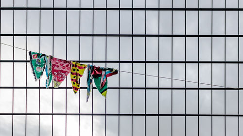Clothes hanging on rope against modern building