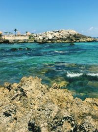 Scenic view of sea against clear blue sky