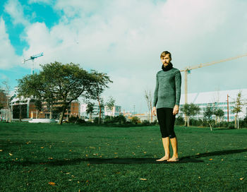 Full length of man standing on field against sky