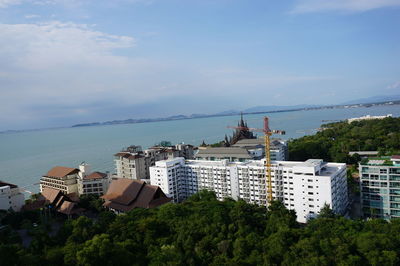 High angle view of buildings by sea against sky