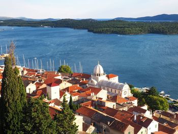 High angle view of townscape by sea