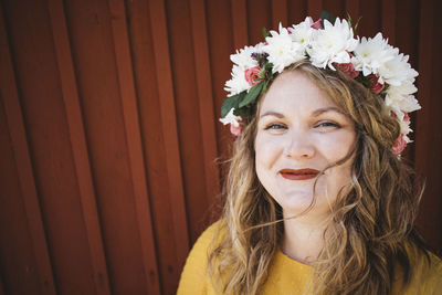 Portrait of smiling woman wearing flower wreath