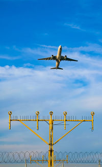 Low angle view of airplane flying against sky