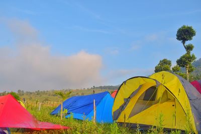 Multi colored tent on field against sky