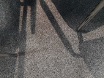 Low section of shadow on floor