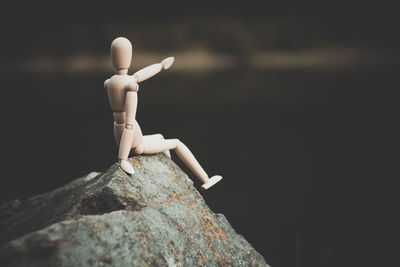 Close-up of figurine on rock