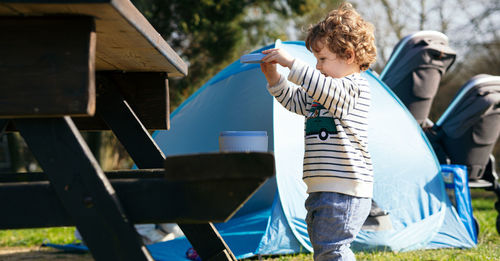 Rear view of boy sitting outdoors