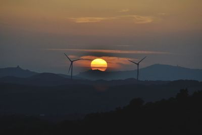 Scenic view of silhouette mountains against sky during sunset