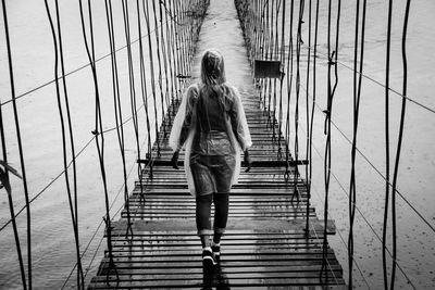 Rear view of woman walking on staircase