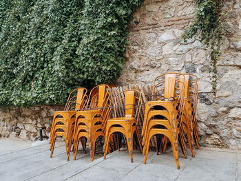 Empty chairs and tables against wall