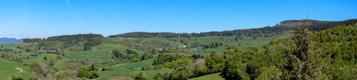 Panoramic view of landscape against clear blue sky