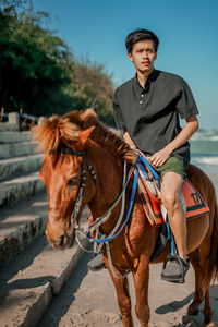 Side view of woman riding horse