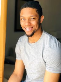 Portrait of smiling young man at home