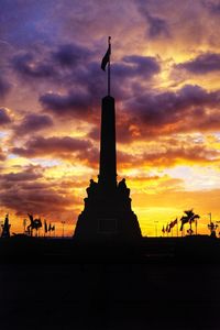 Silhouette of statue at sunset