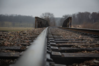 Surface level of railroad tracks against sky