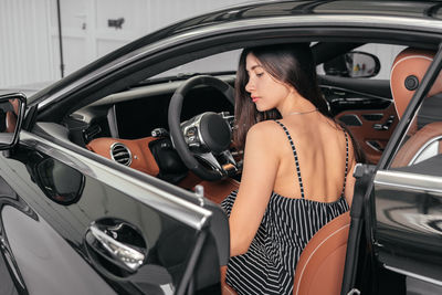 Portrait of a smiling young woman in car