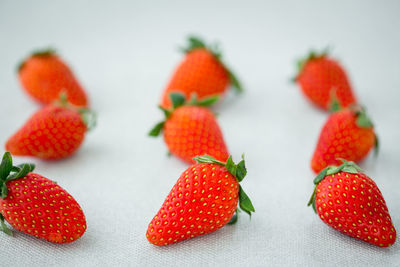 Close-up of strawberries on table against white background