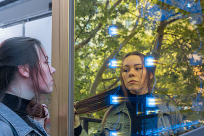 Reflection of woman standing in front of store window