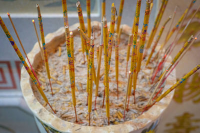 High angle view of yellow incense sticks
