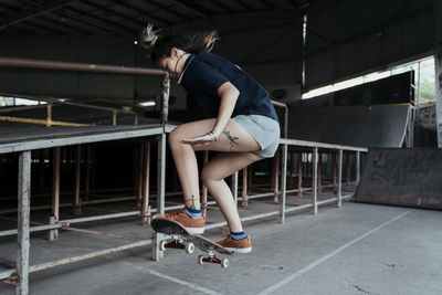 Full length of woman skateboarding on ramp