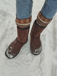 Low section of person standing on snow