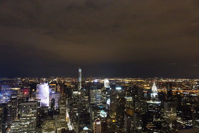 Illuminated cityscape against sky at night