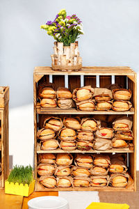 Street food. burgers are wrapped in craft paper on the shelves of a wooden box.