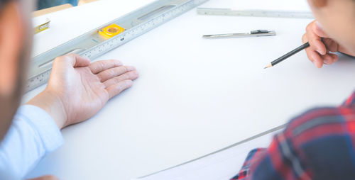 Close-up of people working on table