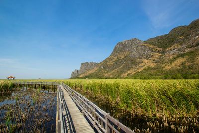 View of railroad tracks on mountain against sky