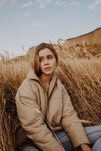 Portrait of woman sitting on field