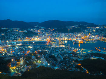 High angle view of illuminated buildings in city at night