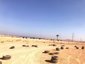 Tires on land against clear sky