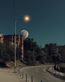 Street lights against clear sky at night