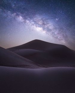 Scenic view of desert against sky at night