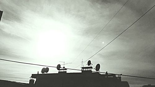 Low angle view of power lines against sky