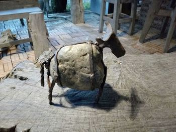 High angle view of sculpture on wood